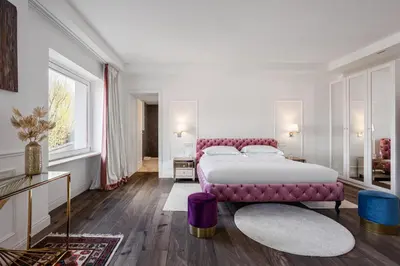 a bedroom with a large bed and a purple couch at Monastero dei Santi in Rome