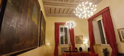 a room with a chandelier and a table in it at Residenza al Pantheon - RH Collection in Rome