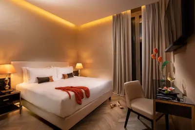 a bedroom with a bed and a desk and a chair at Hotel La Place Roma in Rome