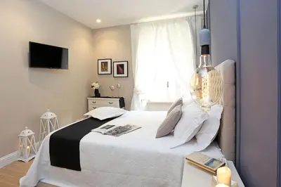 a bedroom with a white bed and a window at Daplace - Lucrezia Apartment in Rome