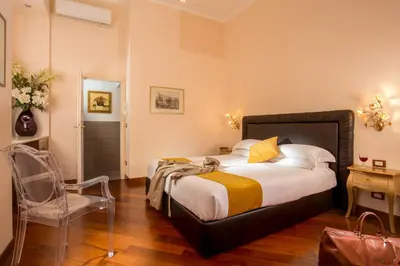 a bedroom with a bed and a chair in it at Flaminia Charme in Rome