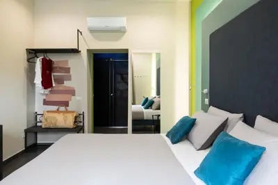a bedroom with a large white bed with blue pillows at Circle in the Square in Rome