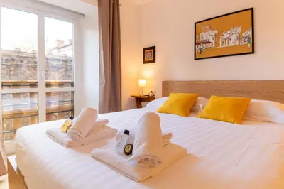 a bedroom with two beds with towels and a window at Domus Domi Barberini Sq. in Rome