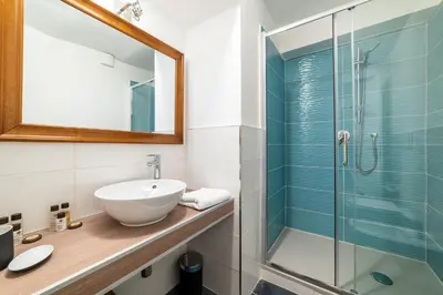 a bathroom with a sink and a shower at Domus Domi Barberini Sq. in Rome
