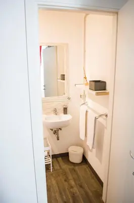 a bathroom with a sink and a toilet and a mirror at Relais Cola Di Rienzo in Rome
