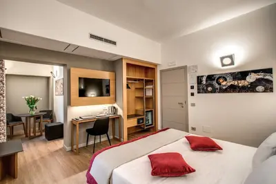 a hotel room with a large bed and a desk at Maison Ripetta in Rome