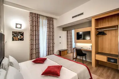 a hotel room with a bed and a desk at Maison Ripetta in Rome