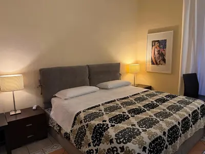 a bedroom with a bed with a black and white comforter at Glamour Center Of Rome in Rome