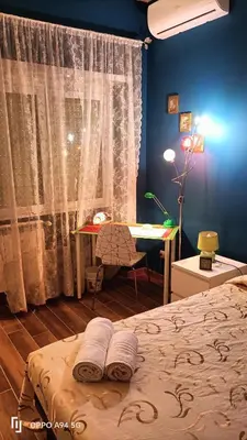 a bedroom with a bed and a desk and a table at Colombo Holidays APT in Rome