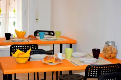 a table with plates and bowls of food on it at Check-Inn Rooms in Rome