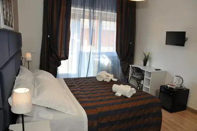 a bedroom with a bed with two stuffed animals on it at Check-Inn Rooms in Rome