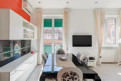 a dining room with a table and chairs and a tv at Casa Flo in Rome