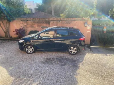 a small car parked in front of a fence at Charming Apartment with Garden, Parking & Metro in Rome