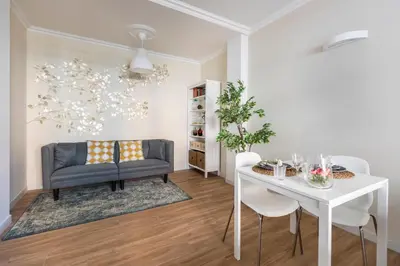 a living room with a table and a chair at Momo Central Rome 2 in Rome