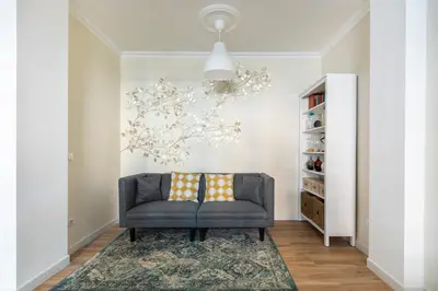a living room with a chair and a rug at Momo Central Rome 2 in Rome