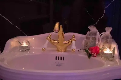 a white sink with a crown on top of it at Erossuite GuestHouse in Rome