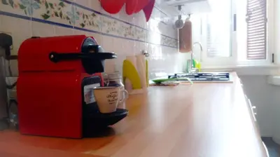 a kitchen with a red coffee maker on a counter at La Favola di San Pietro in Rome