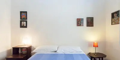 a bedroom with a bed and three pictures on the wall at Libri Flat in Rome