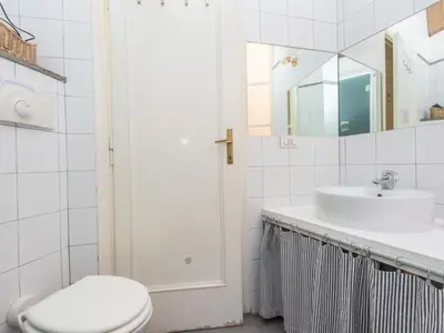 a white bathroom with a sink and a toilet at Apartment Romantico by Interhome in Rome