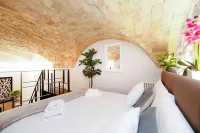 a room with a white bed and a brick ceiling at Post Industrial Loft Trastevere - Top Collection in Rome
