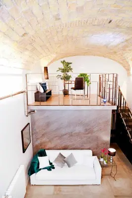 a living room with a white couch and a staircase at Post Industrial Loft Trastevere - Top Collection in Rome