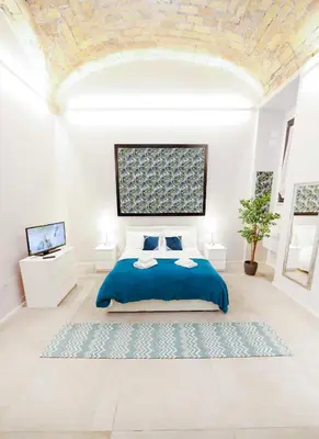a white bedroom with a blue bed and a ceiling at Post Industrial Loft Trastevere - Top Collection in Rome