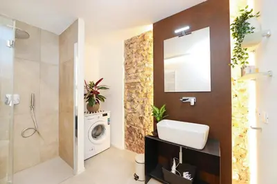 a bathroom with a sink and a washing machine at Sky Dream Loft Trastevere in Rome