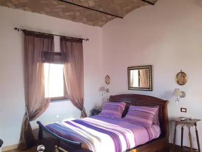a bedroom with a bed and a window at SUPERATTICO SUL COLOSSEO in Rome