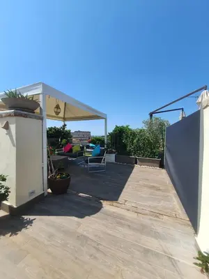 a backyard with a deck with a pergola at SUPERATTICO SUL COLOSSEO in Rome