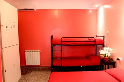 a room with two bunk beds and a red wall at Legend R.G. in Rome