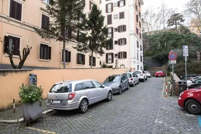a row of cars parked on the side of a street at Silver Luxury Jacuzzi Suite Trastevere in Rome