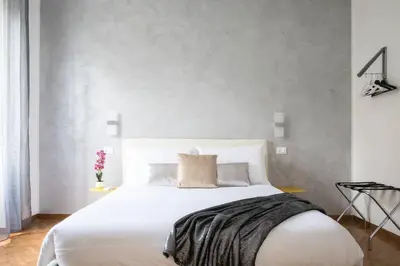 a bedroom with a large white bed in a room at Silver Luxury Jacuzzi Suite Trastevere in Rome
