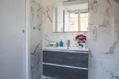 a bathroom with a sink and a mirror at Pink Intimate Jacuzzi Suite Trastevere in Rome