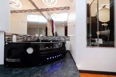 a bathroom with a black sink and a mirror at Black Enchanting Jacuzzi Suite Trastevere in Rome