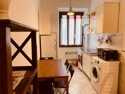 a kitchen with a table and a dining room at Roma family apartment in Rome