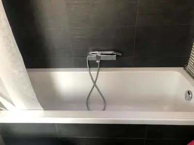 a bath tub with a shower in a bathroom at B&B Affaccio sul Vaticano in Rome