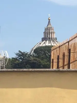 a view of a building with a tower in the background at B&B Affaccio sul Vaticano in Rome
