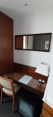 an office desk with a mirror and a chair at Rome Travellers Hotel in Rome