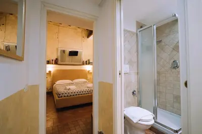 a bathroom with a shower and a toilet in a room at Limani - Navona Private Apartment in Rome