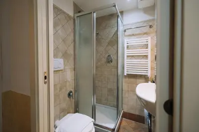 a bathroom with a shower and a sink at Limani - Navona Private Apartment in Rome