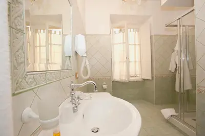 a bathroom with a sink and a mirror and a shower at Sleep In Rome Ludovisi in Rome