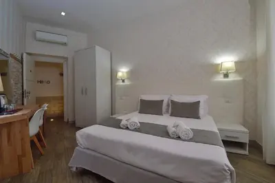 a bedroom with a large bed with towels on it at Rome Vatican Inn in Rome