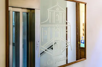 a mirror in a room with a sign on the wall at Casa I Cappuccini in Rome