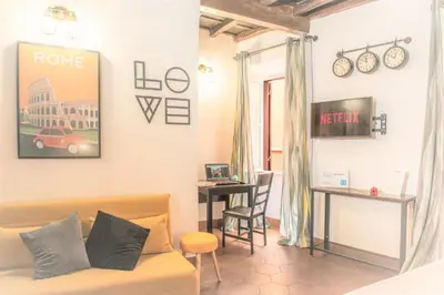 a living room with a couch and a table at Stranamore Apartments Trastevere in Rome