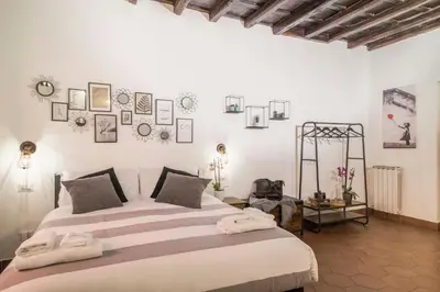 a bedroom with a large bed in a room at Stranamore Apartments Trastevere in Rome