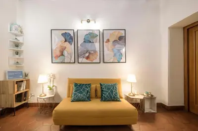 a bedroom with a bed with four pictures on the wall at Stranamore Apartments Trastevere in Rome