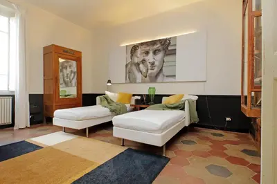 a living room with two white chairs and a table at Michelangelo Charmsuite in Rome