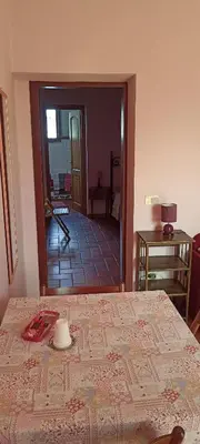 a bedroom with a bed and a room with a mirror at Il Baffetto B&B in Rome