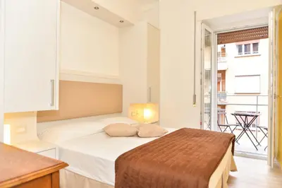 a bedroom with a bed with a mirror on the wall at Your Rhome in Rome