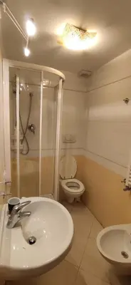 a bedroom with a bed and a desk and a television at Aquila 52 in Rome